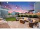 Outdoor entertaining space with a fire pit, comfortable seating, string lights, and privacy fence at 16673 E Virginia Ave, Aurora, CO 80017