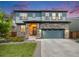 Charming two-story home with stone accents, a two-car garage, and well-maintained front yard at 16673 E Virginia Ave, Aurora, CO 80017