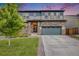 Charming home with a stone facade, well-kept lawn, and a two-car garage at 16673 E Virginia Ave, Aurora, CO 80017