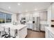 Bright kitchen features stainless steel appliances, white cabinetry and quartz counters at 16673 E Virginia Ave, Aurora, CO 80017