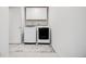 Functional laundry room featuring new front loading washer and dryer with storage cabinets above at 16673 E Virginia Ave, Aurora, CO 80017