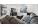 Relaxing living room featuring a comfortable sectional sofa, complemented by natural light from a large window at 16673 E Virginia Ave, Aurora, CO 80017