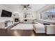 Bright living room with hardwood floors, a fireplace, large sectional sofa, and ample natural light at 16673 E Virginia Ave, Aurora, CO 80017