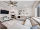 Cozy living room features a fireplace, large sectional sofa, and a ceiling fan at 16673 E Virginia Ave, Aurora, CO 80017