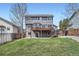 Back exterior view of a well maintained home featuring a two-story deck at 6530 S Tabor St, Littleton, CO 80127
