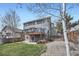 Back exterior view of a well maintained home featuring a two-story deck at 6530 S Tabor St, Littleton, CO 80127