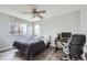 Bedroom featuring wood-look floors, ceiling fan, and work space at 6530 S Tabor St, Littleton, CO 80127