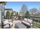 View of an outdoor deck featuring patio furniture and a landscape view of the yard at 6530 S Tabor St, Littleton, CO 80127