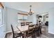 Dining room with wood floors, chandelier, and a window providing ample natural light at 6530 S Tabor St, Littleton, CO 80127