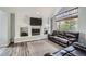 Living room featuring high ceilings, a fireplace, and a large window allowing for plenty of natural light at 6530 S Tabor St, Littleton, CO 80127