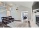 Open concept living room featuring a fireplace, a staircase leading to the second floor, and wood floors at 6530 S Tabor St, Littleton, CO 80127