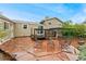 Backyard with stone patio, outdoor seating, pergola, and mature landscaping at 7333 S Dexter Way, Centennial, CO 80122