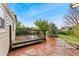 Backyard view with a stone patio, outdoor seating, and mature trees at 7333 S Dexter Way, Centennial, CO 80122