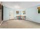 Finished basement featuring neutral carpet, windows, and an external door at 7333 S Dexter Way, Centennial, CO 80122