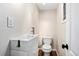 Stylish half bathroom featuring modern fixtures, vanity and hardwood flooring at 7333 S Dexter Way, Centennial, CO 80122