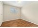 Empty bedroom features hardwood floors and window at 7333 S Dexter Way, Centennial, CO 80122