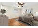 Staged bedroom featuring wood floors, ceiling fan and comfortable decor at 7333 S Dexter Way, Centennial, CO 80122