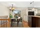 Inviting dining area adjacent to the kitchen, featuring a stylish chandelier and access to an outdoor deck at 7333 S Dexter Way, Centennial, CO 80122
