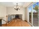 Light-filled dining area offering deck access, elegant chandelier, and hardwood floors at 7333 S Dexter Way, Centennial, CO 80122