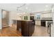 Eat-in kitchen featuring tile flooring, an island, and stainless steel appliances at 7333 S Dexter Way, Centennial, CO 80122
