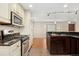 Inviting kitchen with stainless steel appliances, granite counters, and a seamless flow to an adjacent dining area at 7333 S Dexter Way, Centennial, CO 80122