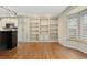 Open concept kitchen featuring white cabinets, hardwood floors, and built-in bookcase at 7333 S Dexter Way, Centennial, CO 80122