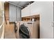 Laundry area with front load washer and dryer and cabinet space at 7333 S Dexter Way, Centennial, CO 80122