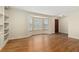 Bright living room featuring gleaming hardwood floors, built-in bookcase and a front door at 7333 S Dexter Way, Centennial, CO 80122