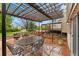 Outdoor patio with a dining table, a pergola, and a view of the landscaped yard at 7333 S Dexter Way, Centennial, CO 80122
