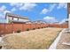 Fenced backyard with a well-maintained lawn, small bushes, and rock features, providing a serene outdoor space at 25064 E Archer Pl, Aurora, CO 80018