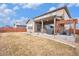 Backyard with patio, featuring a built-in grill and adjacent seating area at 25064 E Archer Pl, Aurora, CO 80018