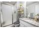 Bathroom featuring granite vanity, modern fixtures, and a glass-enclosed shower at 25064 E Archer Pl, Aurora, CO 80018