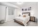 Cozy bedroom with a queen-sized bed, two nightstands, and bright natural light from the large window at 25064 E Archer Pl, Aurora, CO 80018