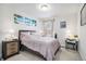 Comfortable bedroom with neutral decor, a bright window, and a desk area with beach-themed decor at 25064 E Archer Pl, Aurora, CO 80018