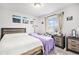 Bright bedroom with two beds, each covered in a different color and coastal themed paintings on the wall at 25064 E Archer Pl, Aurora, CO 80018