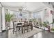 Bright dining room with a wooden table, white curtains, and a view of the outdoors at 25064 E Archer Pl, Aurora, CO 80018