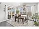 Bright dining area featuring a wooden table with seating and large sliding glass doors at 25064 E Archer Pl, Aurora, CO 80018