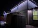 The exterior of the home shows a shed with string lights at night at 25064 E Archer Pl, Aurora, CO 80018