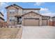 Charming two-story home featuring a stone and siding facade, complemented by a spacious driveway and well-kept lawn at 25064 E Archer Pl, Aurora, CO 80018