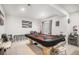 Game room with a poker table, bar area, neutral carpet, and a window with natural light at 25064 E Archer Pl, Aurora, CO 80018