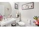 Stylish half bathroom with pedestal sink, elegant mirror, and decorative accents at 25064 E Archer Pl, Aurora, CO 80018