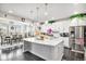 Modern kitchen with a large island, stainless steel appliances, and an adjacent dining area at 25064 E Archer Pl, Aurora, CO 80018