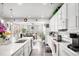 Bright kitchen with a large island, white cabinetry, and stainless steel appliances at 25064 E Archer Pl, Aurora, CO 80018