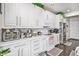 Bright kitchen with white cabinetry, stainless steel appliances, and stone countertops at 25064 E Archer Pl, Aurora, CO 80018