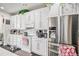 Bright kitchen featuring white cabinets, stainless steel appliances and white countertops at 25064 E Archer Pl, Aurora, CO 80018