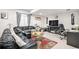 Cozy living room with black leather sofas, colorful rug and a fireplace, creating an inviting and relaxing atmosphere at 25064 E Archer Pl, Aurora, CO 80018