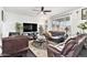 Cozy living room offers comfortable leather furniture, a fireplace, and natural light from a large window at 25064 E Archer Pl, Aurora, CO 80018