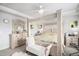 Bright main bedroom features a four poster bed, light colored wood furniture and coastal-themed decorations at 25064 E Archer Pl, Aurora, CO 80018