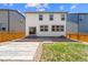 Landscaped backyard with a stone patio, small lawn, and a wooden fence at 19131 E 65Th Ave, Denver, CO 80249