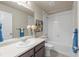 Well-lit full bathroom with tile flooring, white tiling in the shower/tub, and modern vanity at 19131 E 65Th Ave, Denver, CO 80249